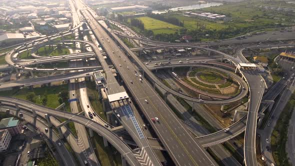 Aerial View of Highway Road Interchange with Busy Urban Traffic Speeding on Road