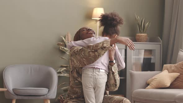 Woman Soldier Reuniting with Little Daughter at Home alt