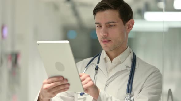 Portrait of Male Doctor Using Tablet in Office