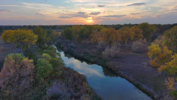 Autumn colors are echoes in the sky above the Platte river in Northern Colorado.