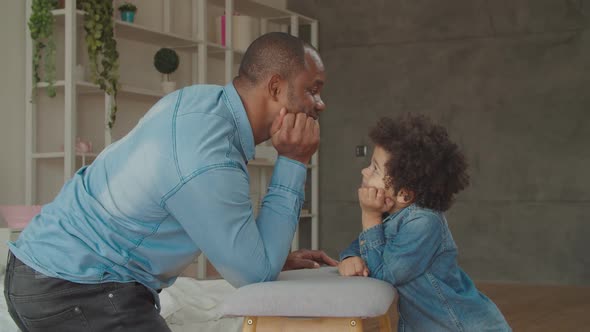 Black Father and Son Playing Staring Contest