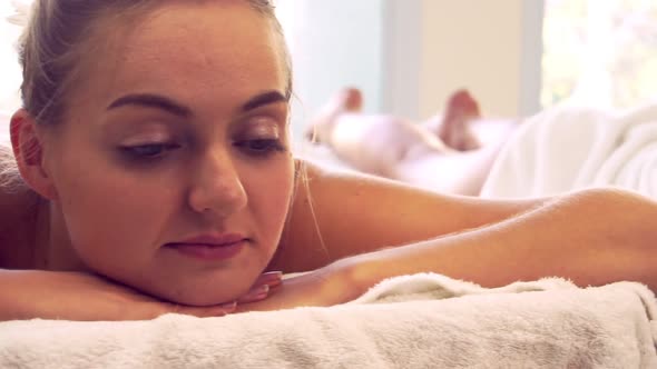 Relaxed Young Woman Lying on Spa Bed for Massage