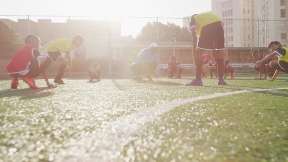 Soccer kids exercising in a sunny day