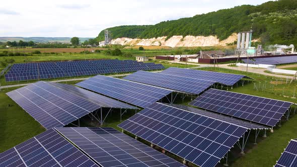 Aerial View of Electrical Power Plant with Rows of Solar Photovoltaic Panels for Producing Clean