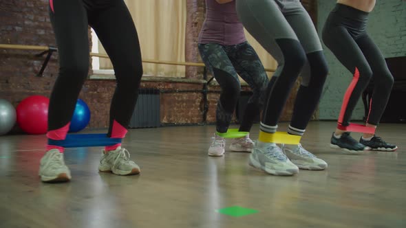 Active Fit Women Doing Banded Squat Walks Exercise