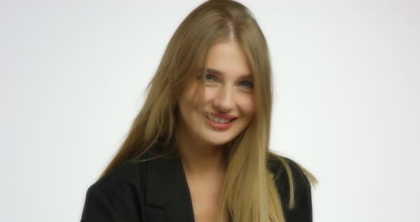 Beautiful Young Woman Poses in the Studio on Camera on a White Background