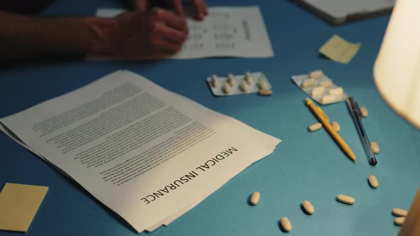 Medical Insurance Sheet on the Table with Medicines