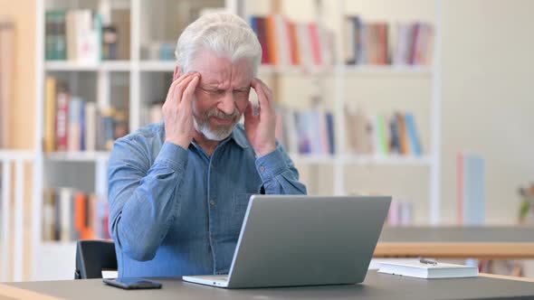 Stressed Old Man Having Headache at Work