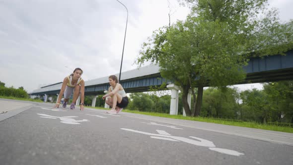 Sportswoman Runs From Crunch Start Position Near Friend