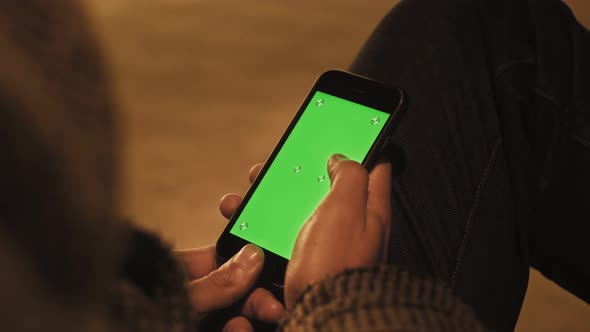 Handheld Camera Point of View of Business Man Using Smartphone Viewing Green Screen on Mobile Phone