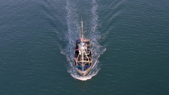 Fishing Boat in the Early Morning Heading Out to Sea