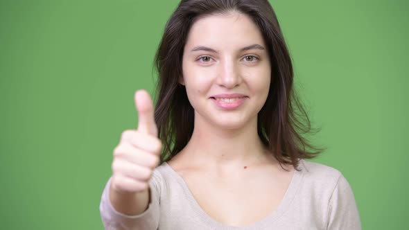 Young Happy Beautiful Woman Smiling While Giving Thumbs Up