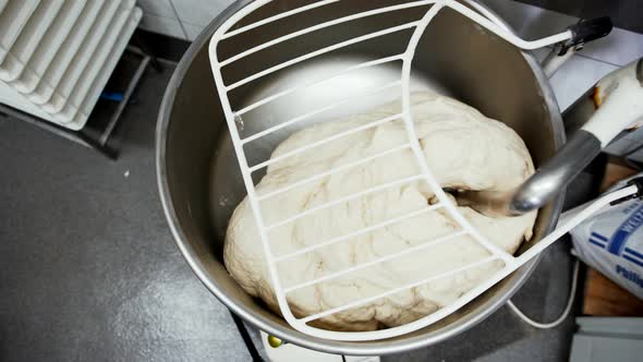 Overhead View of Raw Dough Being Mixed By a Machine