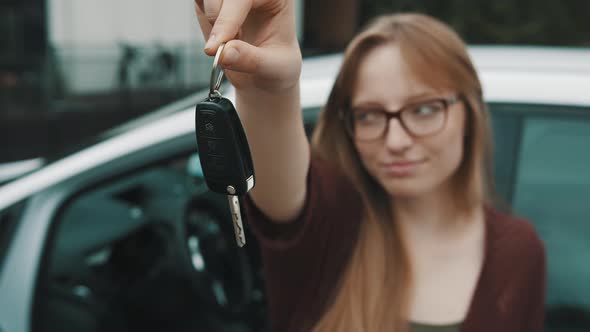 Young Caucasian Happy Womanin Front of the New Car and Holding Keys