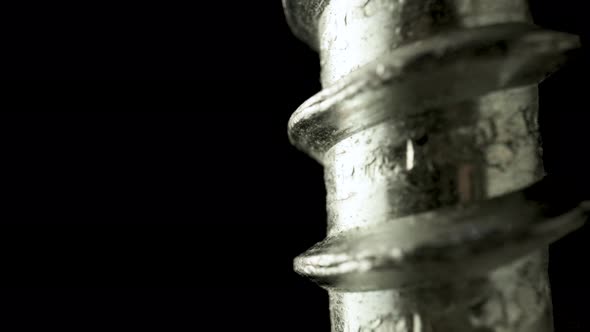 Part of a Stainless Spiral Screw Thread on an Isolated Black Background