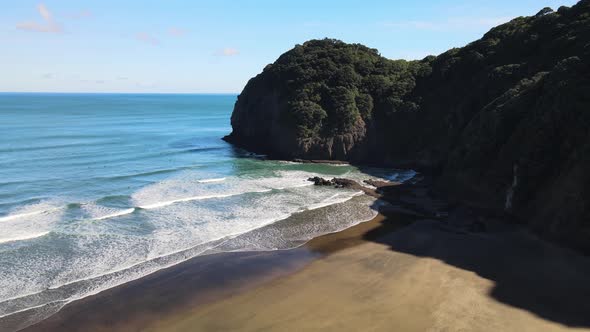 Reflections at low tide on black sand beach