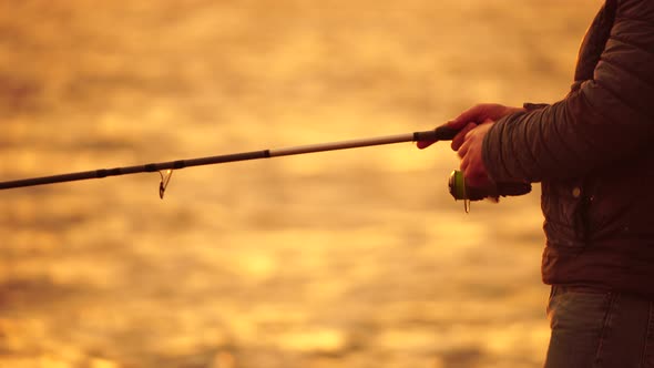 Man Hobby Fishing on Sea Tightens a Fishing Line Reel of Fish Summer