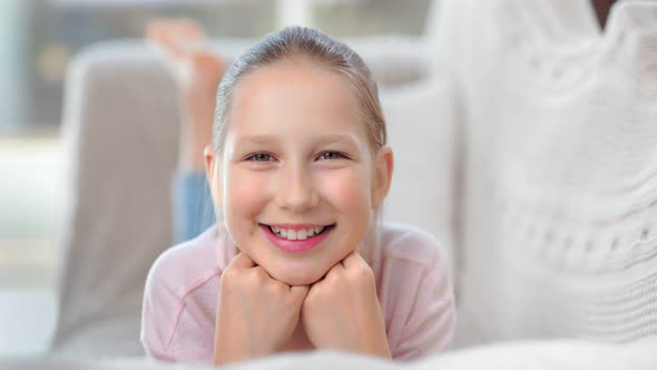 Closeup Face of Funny Cute Healthy Child Girl Relaxing on Couch Enjoying Childhood