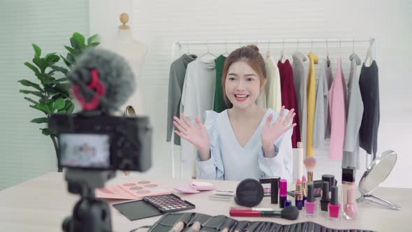 Beauty blogger present beauty cosmetics sitting in front camera for recording video