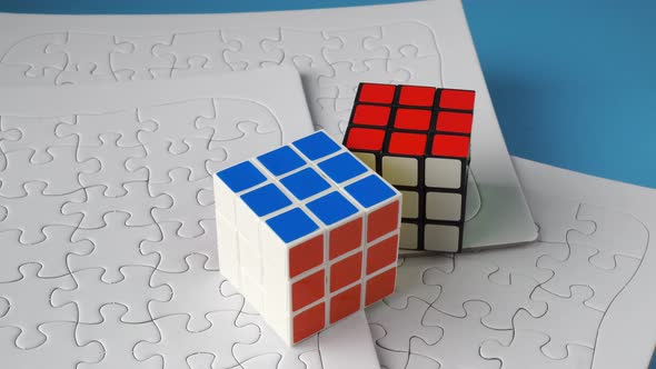Rubik cube in white jigsaw puzzle.