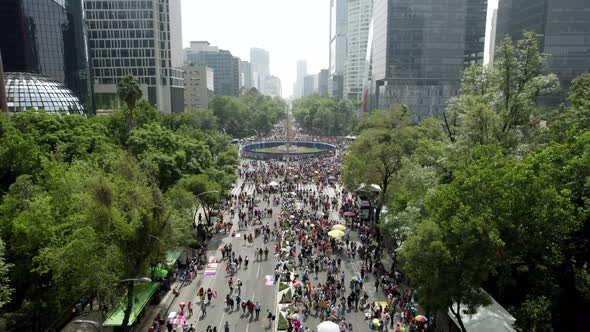 drone shot of people during pride parade at roundabout in mexico city