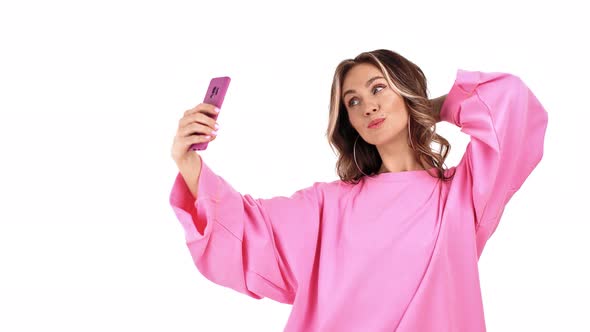 Adorable Female in Pink Jumper Posing Taking Selfie on Mobile Phone