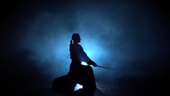 Silhouette Aikido Master Wearing Traditional Samurai Hakama Clothes Takes His Japanese Sword Out