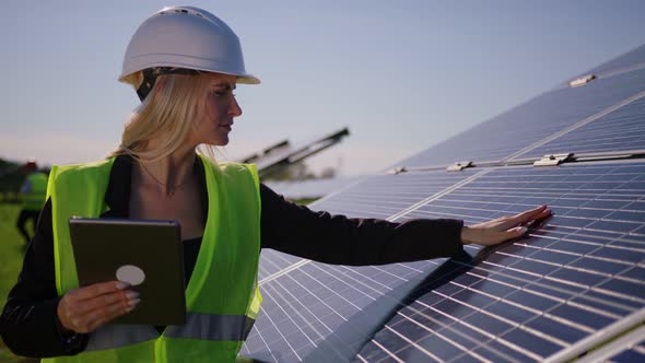 Female Ecological Engineer Uses Digital Tablet and Collects Efficient Information About Solar Panels