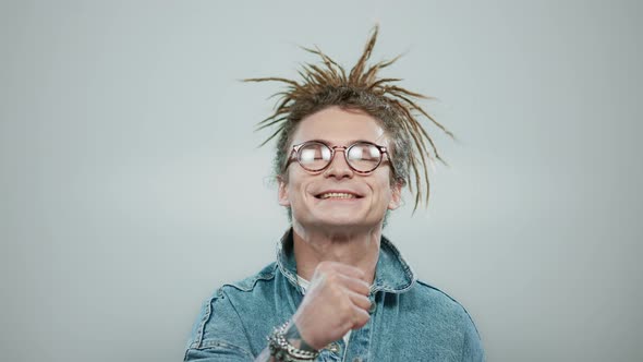 Excited Man Celebrating Success in Studio. Happy Guy Showing Yes Gesture