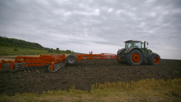 Harvesting in the Field. Land Cultivation with a Tractor