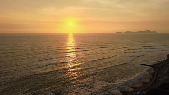 Drone shot of a beautiful sunset over the sea in the Pacific coast of South America