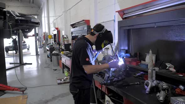 welding in slow motion in a mechanic garage