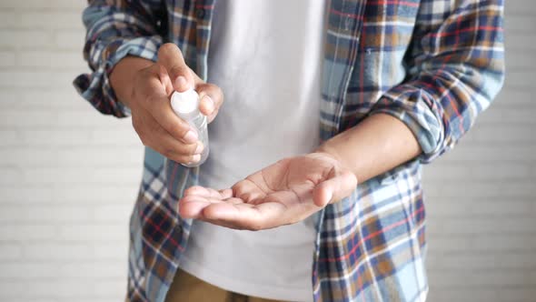 Close Up of Young Man Hand Using Hand Sanitizer Spray