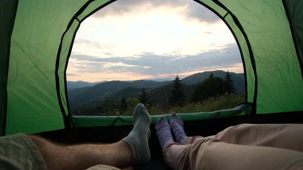 Loving Couple of Tourists Resting in a Tent Conquering the Top