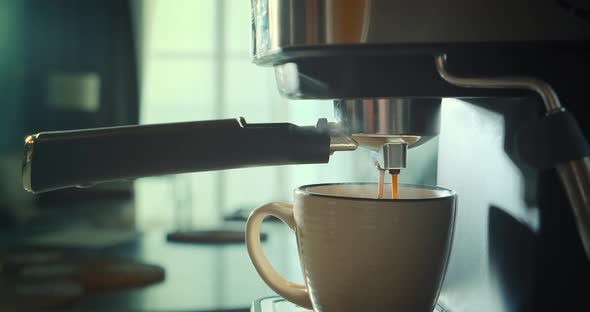 Pouring Coffee Stream From Machine in Cup