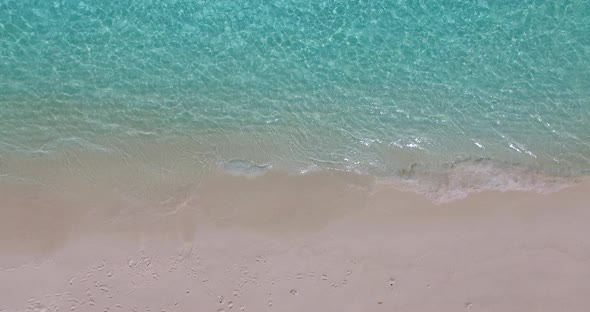 Natural above travel shot of a paradise sunny white sand beach and aqua blue water background in col
