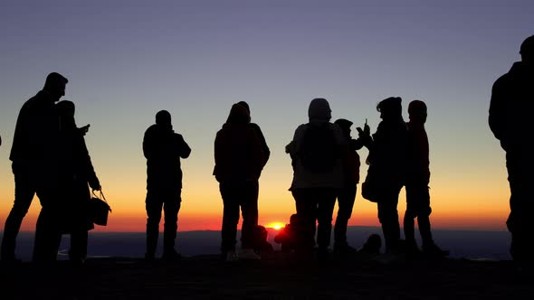 Silhouette of Unidentified People at the Top of Nemrut Mountain Watching Sunrise