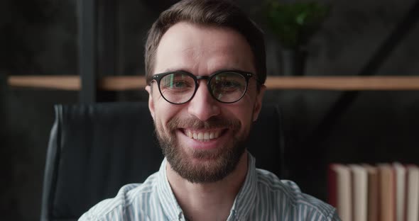 Close Up Face of Bearded Professional Businessman in Eyeglasses Turning and Looking at the Camera