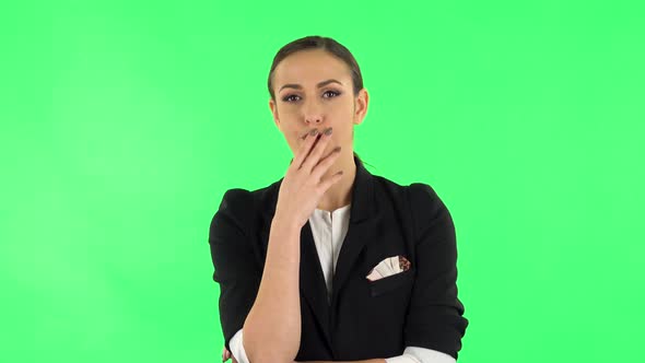 Female Listens Attentively and Nods His Head Pointing Finger at Viewer. Green Screen