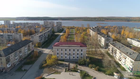 Aerial view of house of culture, alley and pond in a provincial autumn town 19