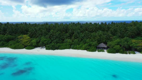 Daytime birds eye abstract shot of a sandy white paradise beach and aqua turquoise water background 