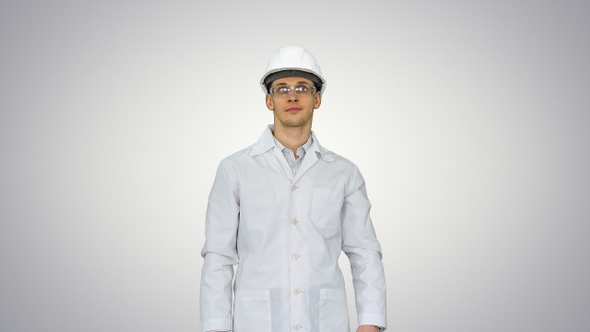 Scientist Engineer in white robe safety helmet and glasses