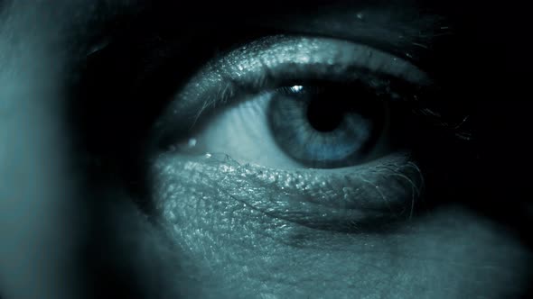 Macro Footage of the Eye. Blood Vessels on the Eyes. Eyelashes in Macro. Dramatic Dark Light. Close