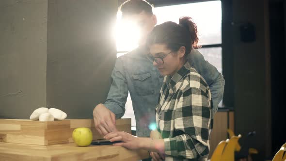 Slow Motion Footage of Two Attractive People Scrolling Something on Smartphone and Spending Time