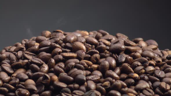 Closeup Heap Roasted Coffee Grains on Dark Backdrop