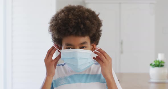 Young boy wearing face mask at home