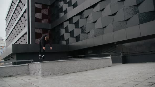 Young Man Does Flips and Jumps Parkour on Modern City Free Running in  Slow Motion