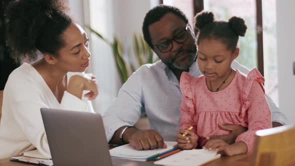 Parents talking and showing something to daughter