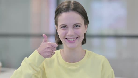 Portrait of Young Woman Showing Thumbs Up Sign