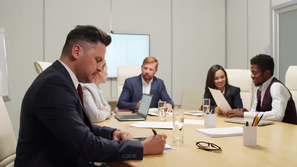 Portrait of Businessman in Meeting